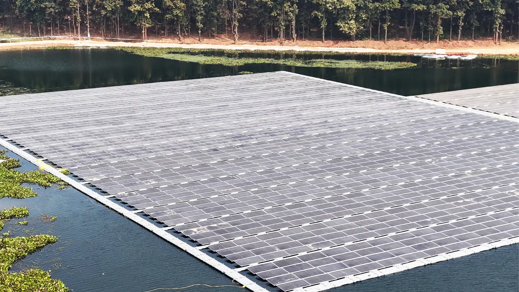 A floating solar power plant under deployment on a reservoir