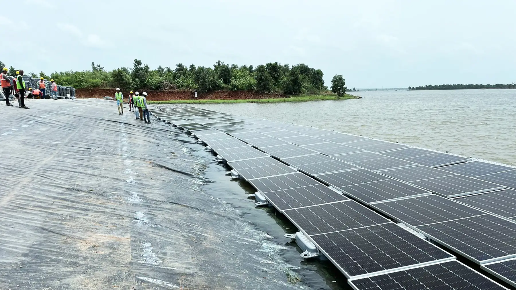 Floating solar panels on a reservoir representing cross-border clean energy collaboration
