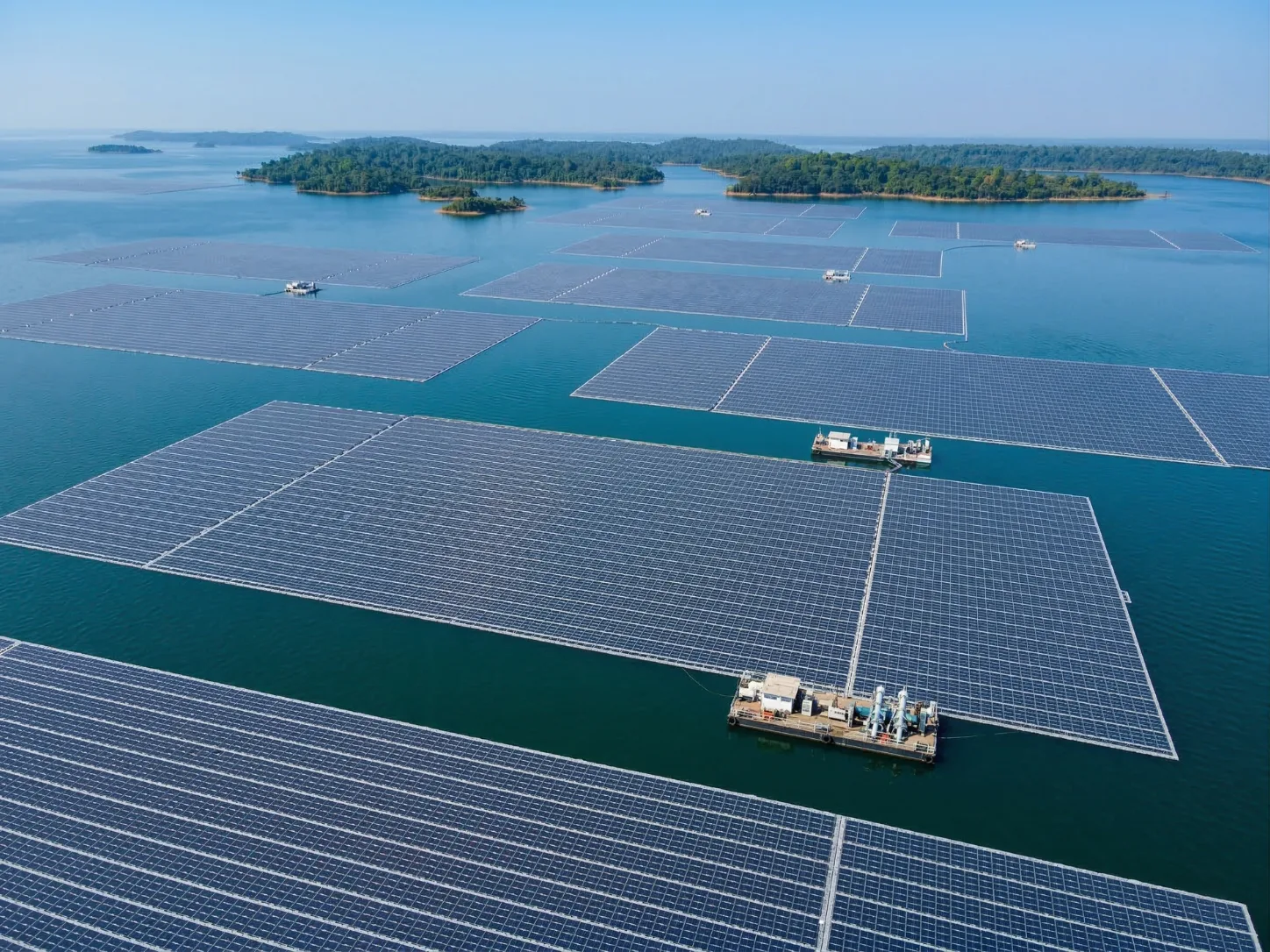Aerial view of a large utility-scale floating solar array on a reservoir, representing Floatex Solar's 1 GW+ project portfolio